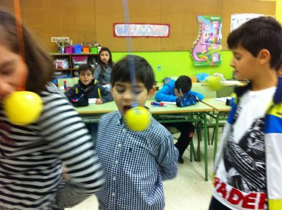 The third graders playing apples bobbing
