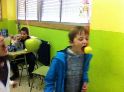 The third graders playing apples bobbing
