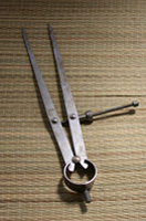 Imagen de un compás de puntas para trazar. Ambos pies del compás terminan en puntas metálicas. 